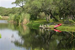 Canoes By The Lake Front